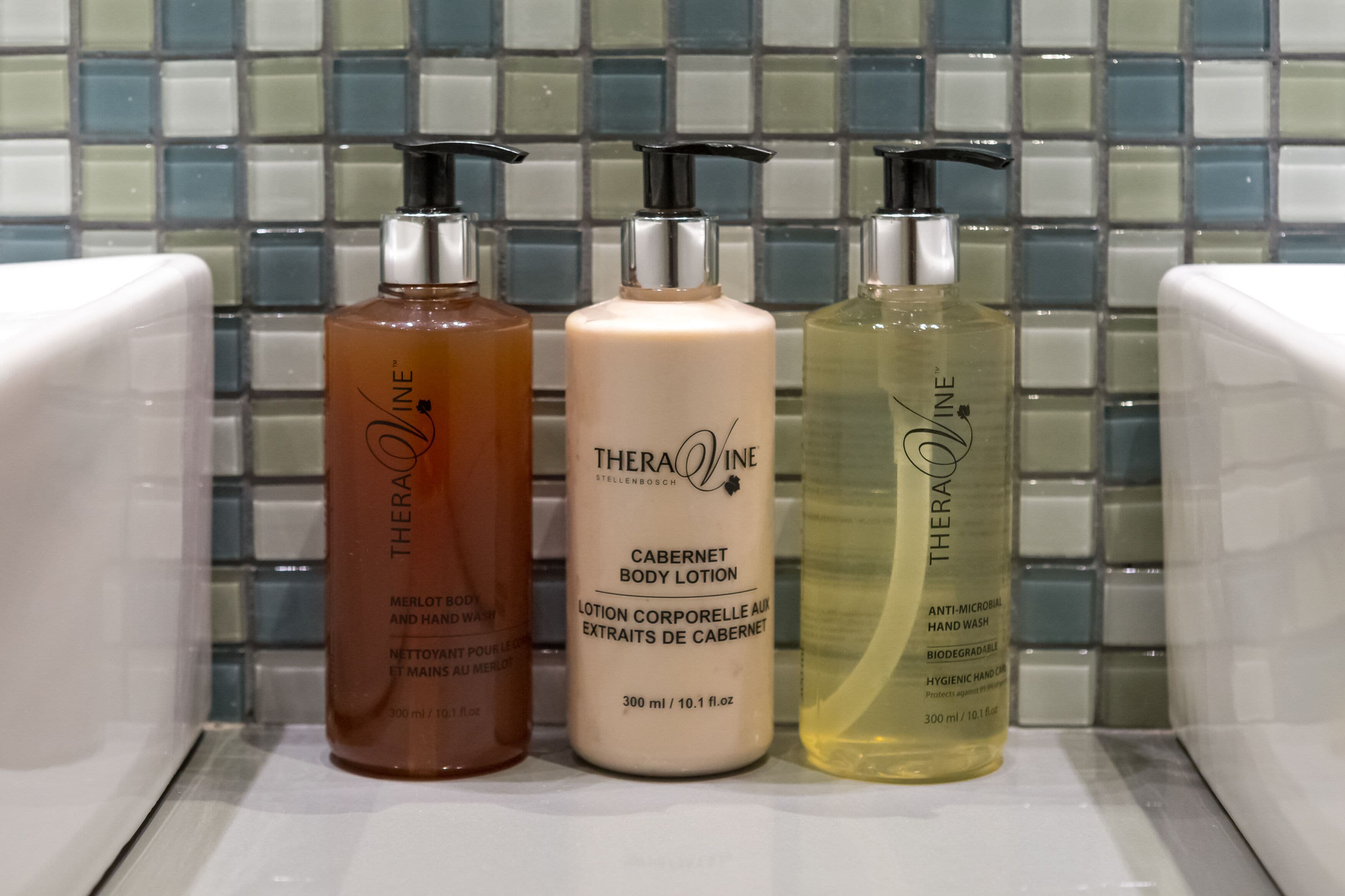 Three bottles of Theravine body lotion on a shelf.