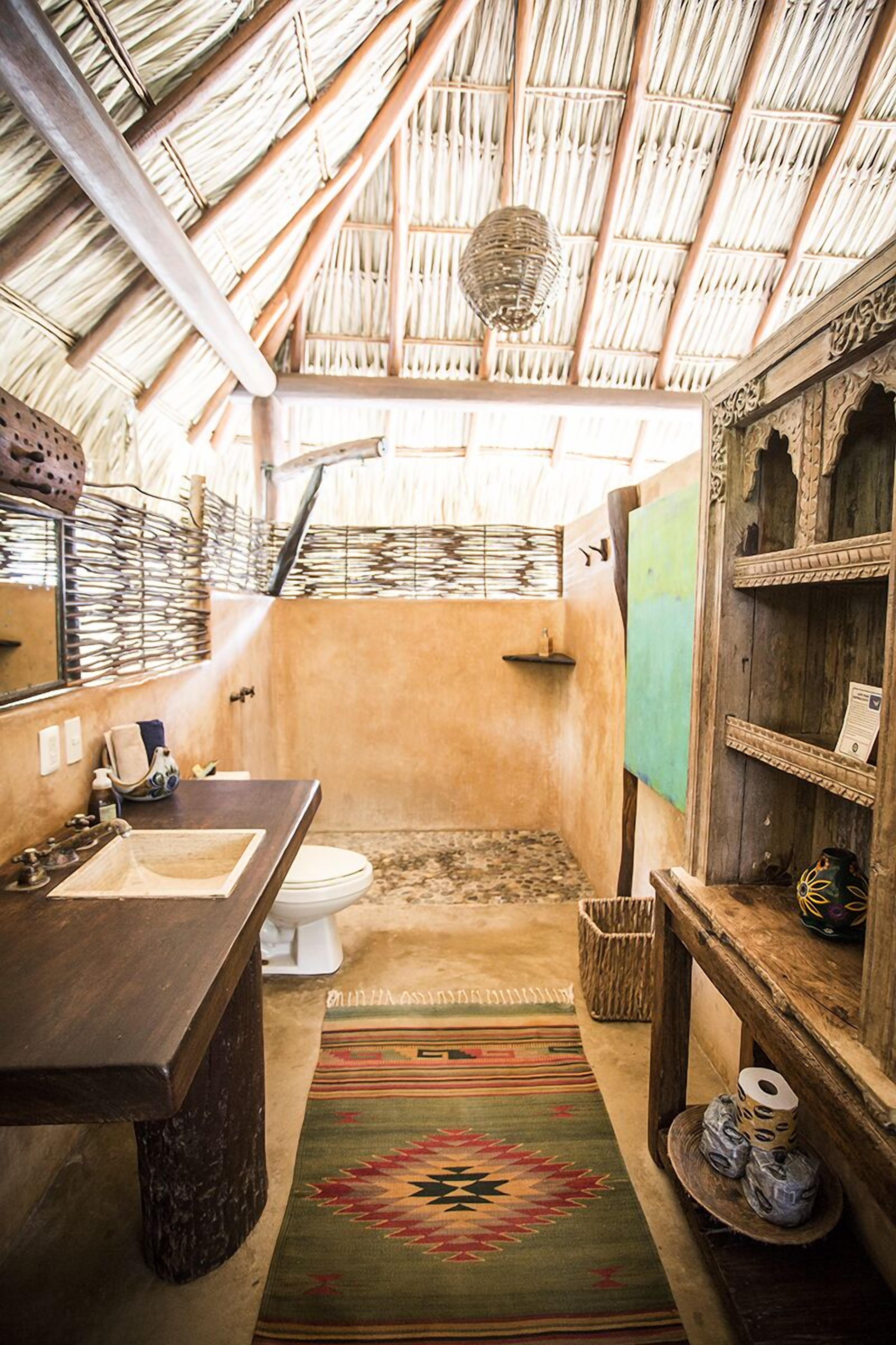 deluxe bungalow | bathroom | shower, rainfall showerhead, hair dryer, towels