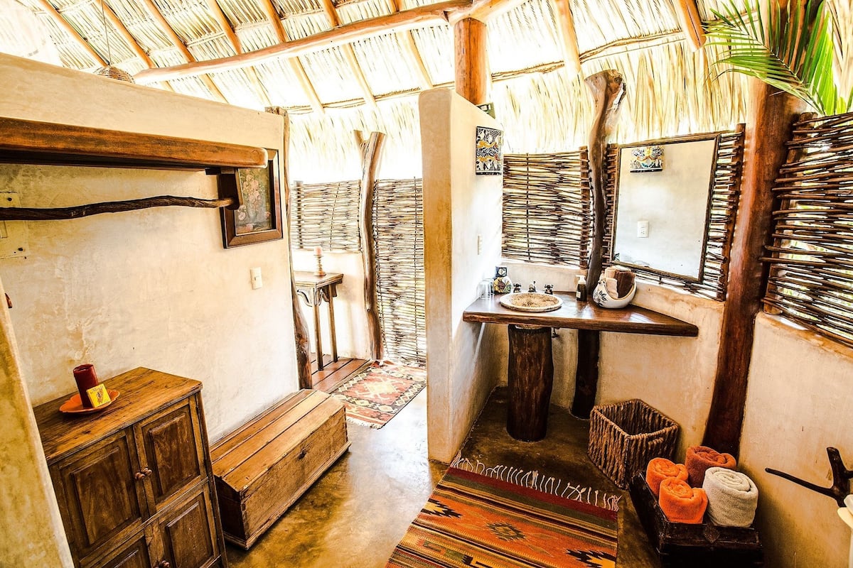 deluxe bungalow | bathroom | shower, rainfall showerhead, hair dryer, towels