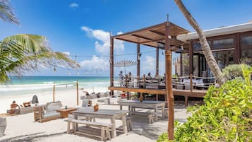 En la playa, playa de arena blanca, camastros y sombrillas