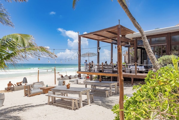 On the beach, white sand, sun loungers, beach umbrellas