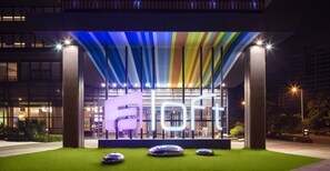 A modern building with a large illuminated sign reading "soft" and a colorful striped roof. - Aloft Guangzhou University Park (Guangzhou)