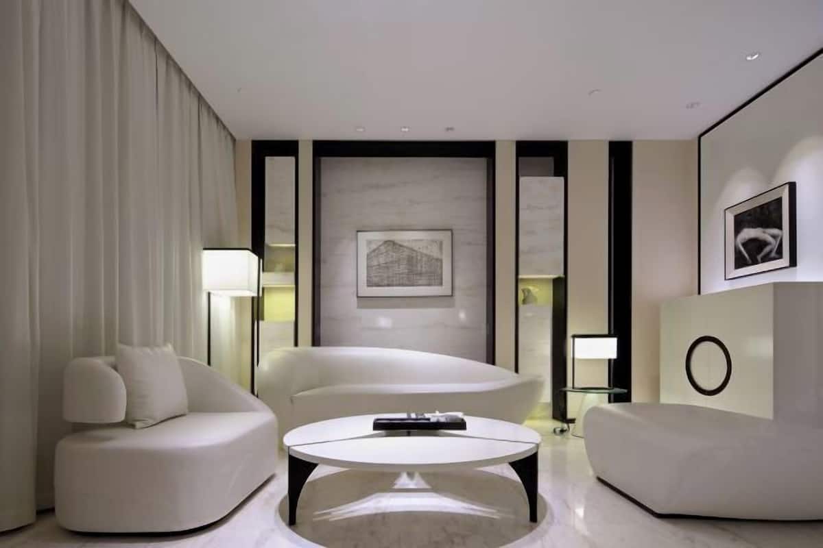 A modern living room with a sofa, a coffee table, and a framed picture on the wall.