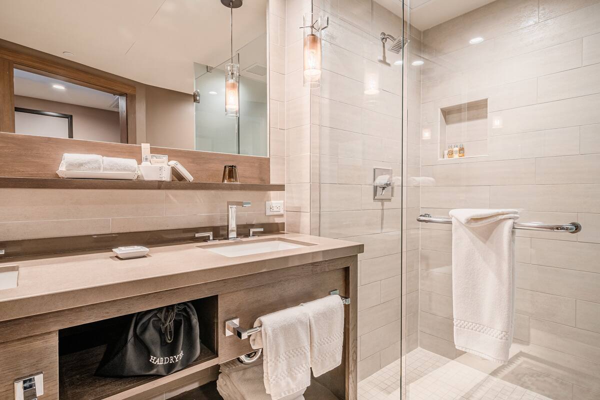 designer toiletries, hair dryer, bathrobes, slippers