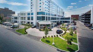 A modern hotel with a central courtyard, multiple parking levels, and a prominent glass facade. - Residence Inn New York The Bronx At Metro Center Atrium (Bronx)