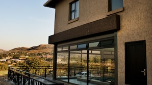 A modern building with large windows and a balcony. - Eagle Nest Luxury Accommodation (Roodepoort)