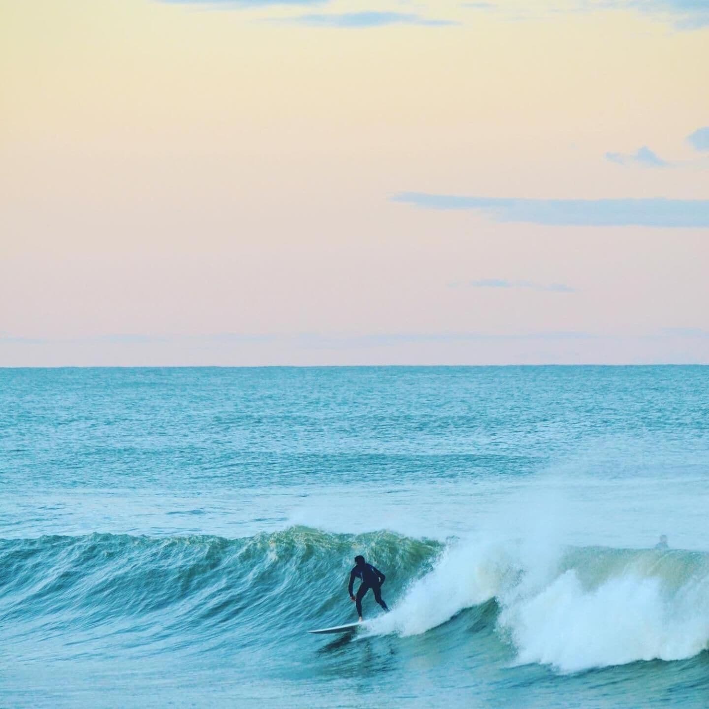 A person surfing a wave in the ocean.