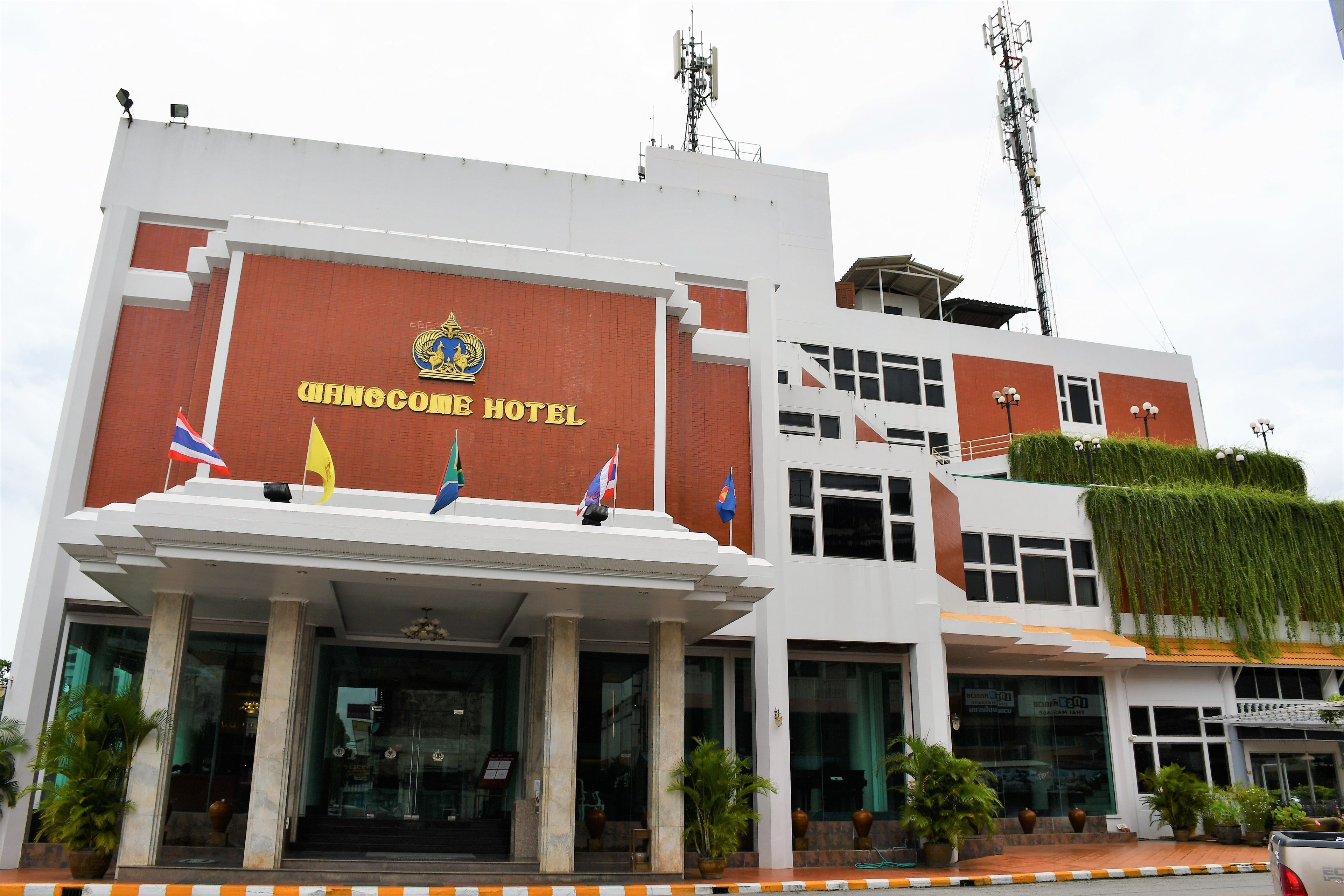 A hotel with a prominent sign reading "Wangome Hotel".