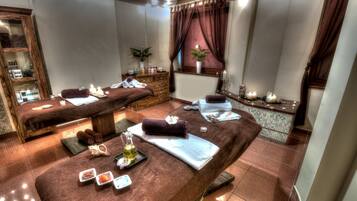 Experience a serene spa retreat with two massage tables, a selection of spa amenities, and a peaceful atmosphere.