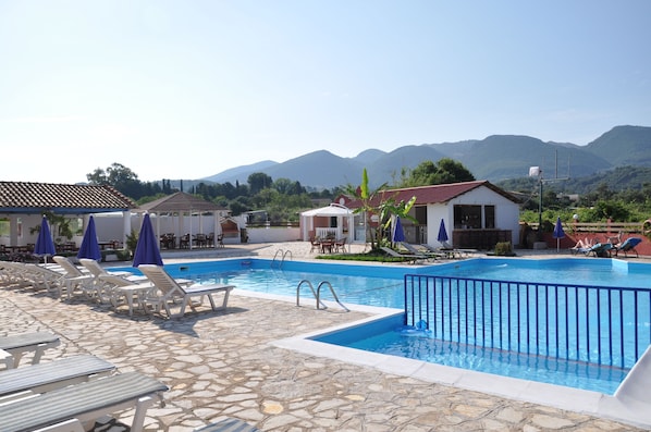 Outdoor pool, open 9:00 AM to 8:00 PM, pool umbrellas, pool loungers