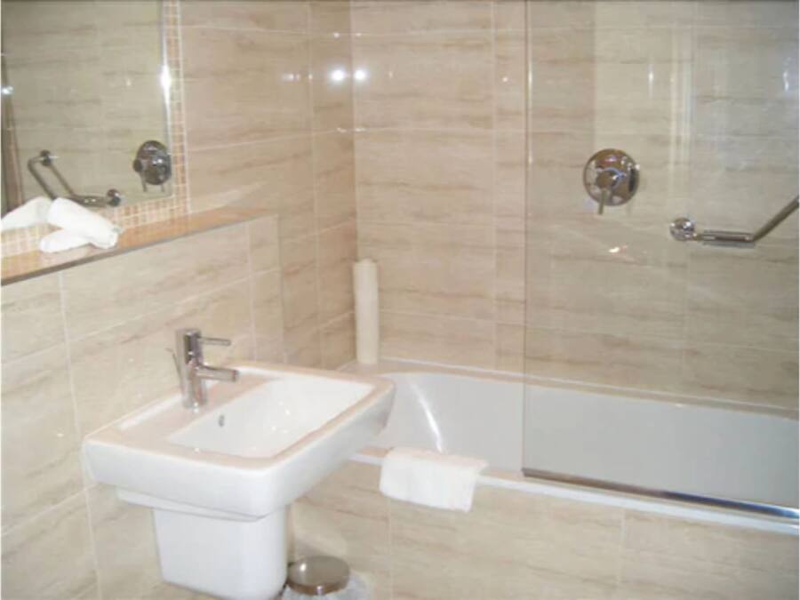 A bathroom with a sink, toilet, and bathtub.