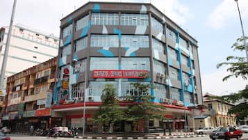 A multi-story building with a prominent sign for "HOTEL IPOH BOUTIQUE".