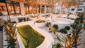 A modern outdoor area with a pool, seating, and plants. - Hotel Denver (Mar del Plata)