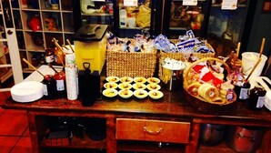 A bar area with a variety of food items and condiments displayed on the counter. - Adelaide Hostel (San Francisco)