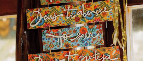 A wooden structure with colorful, floral-patterned signs hanging from it.