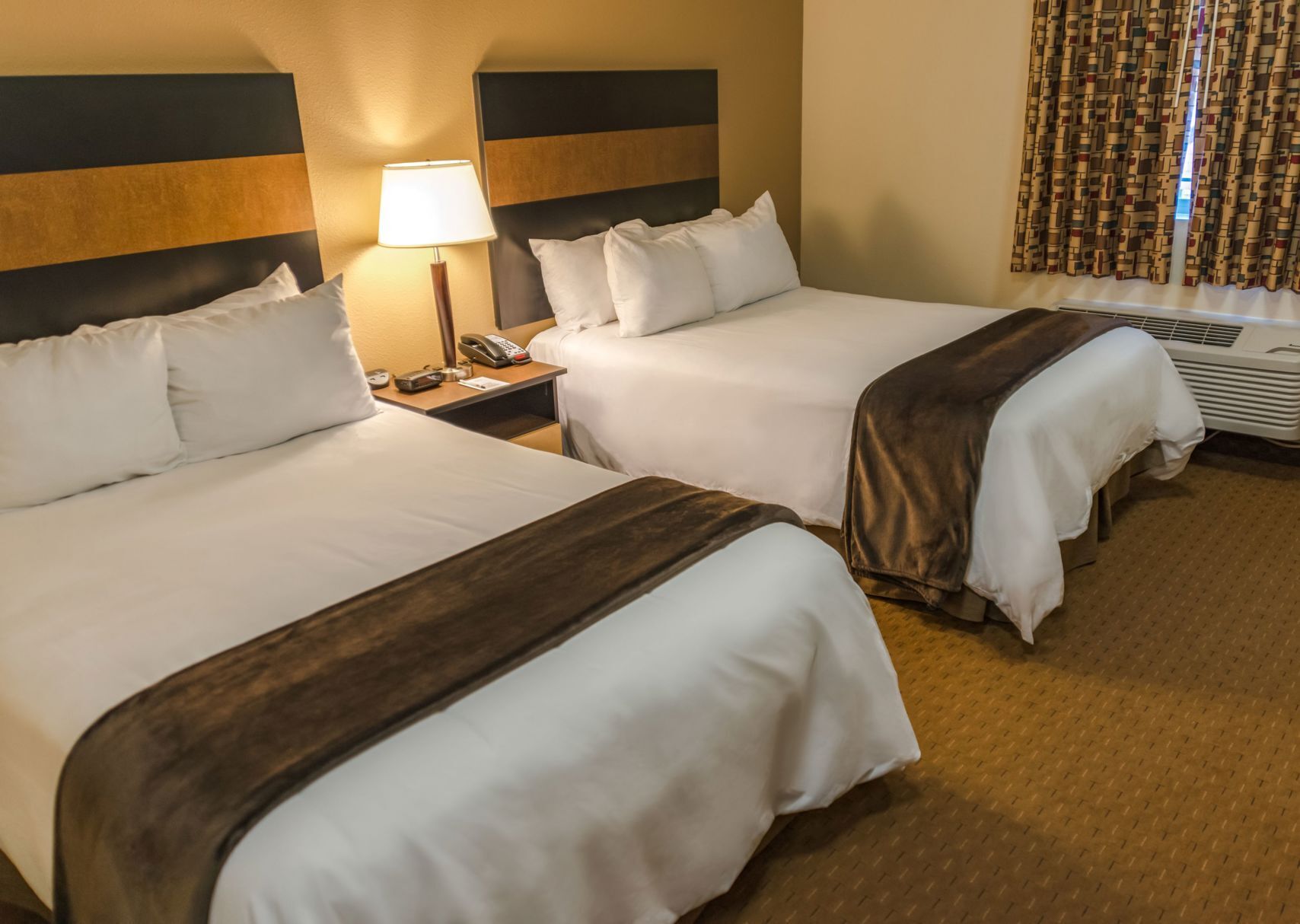 Premium bedding, pillow-top beds, desk, laptop workspace