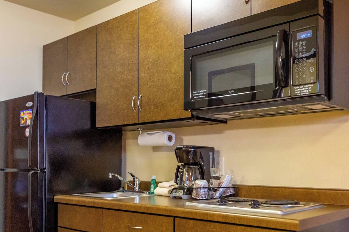 full-sized fridge, microwave, stovetop, coffee/tea maker