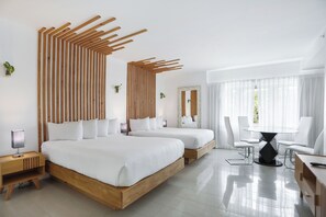 A modern hotel room with two beds, a dining table, and a large window with sheer curtains. - Hotel Belleza (Miami Beach)