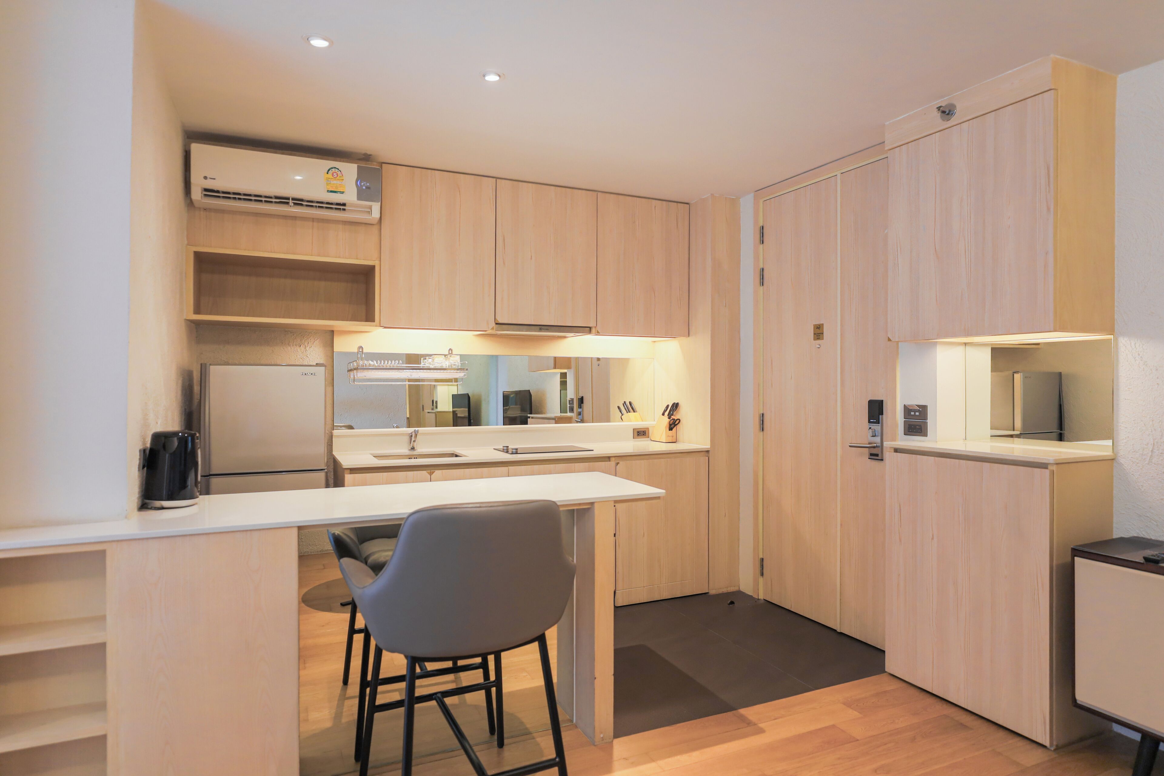 A compact kitchen with a central island, a built-in oven, and a microwave.