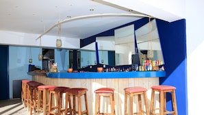 A bar area with wooden stools and a blue counter. - Mika Villas & Suites (Hersonissos)