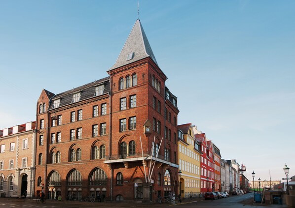 A historic red brick building with a prominent tower, large arched windows, and a flat roof. - Hotel Bethel (Copenhagen)