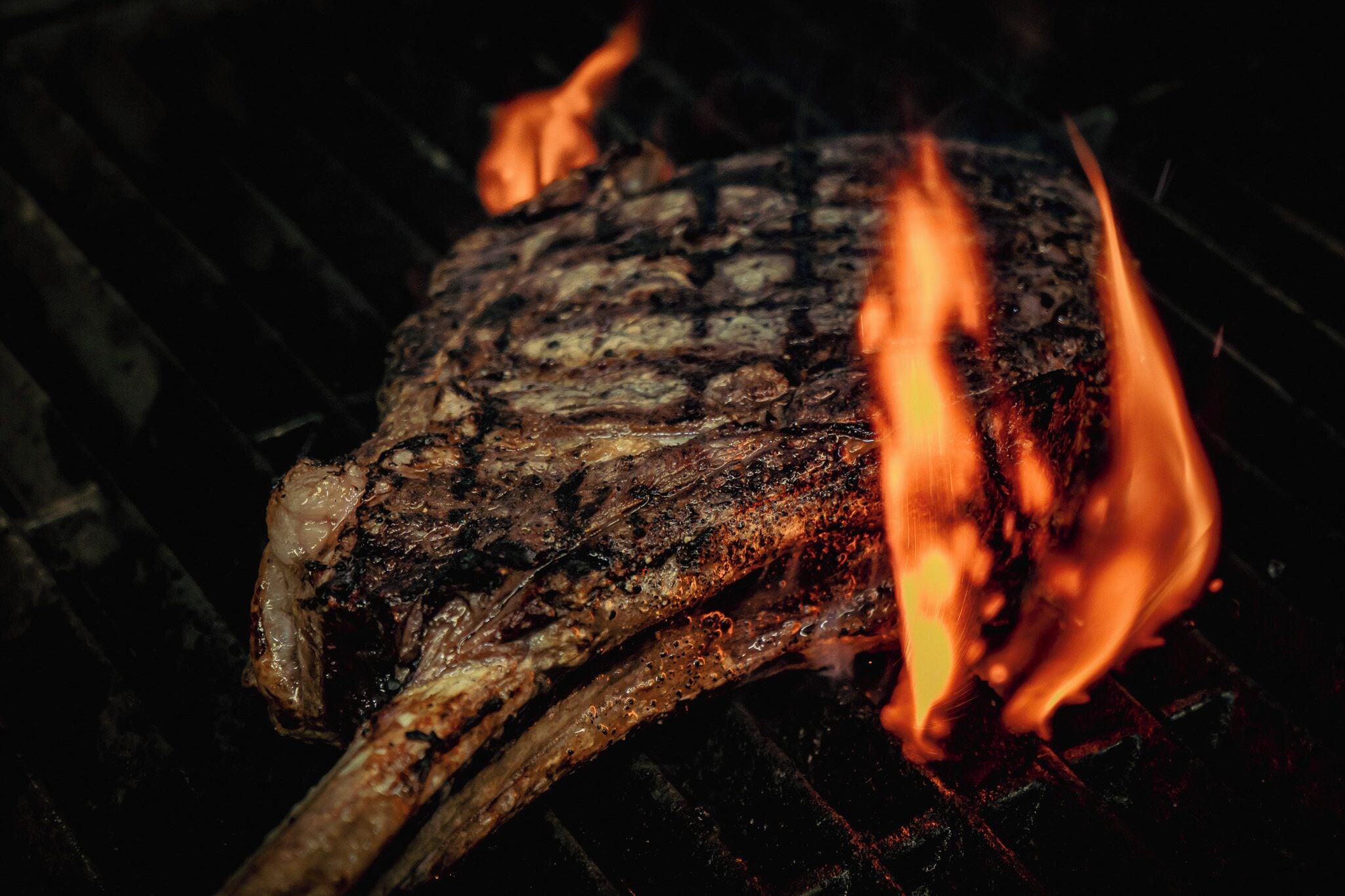 A grilled steak with visible char marks on a grill.