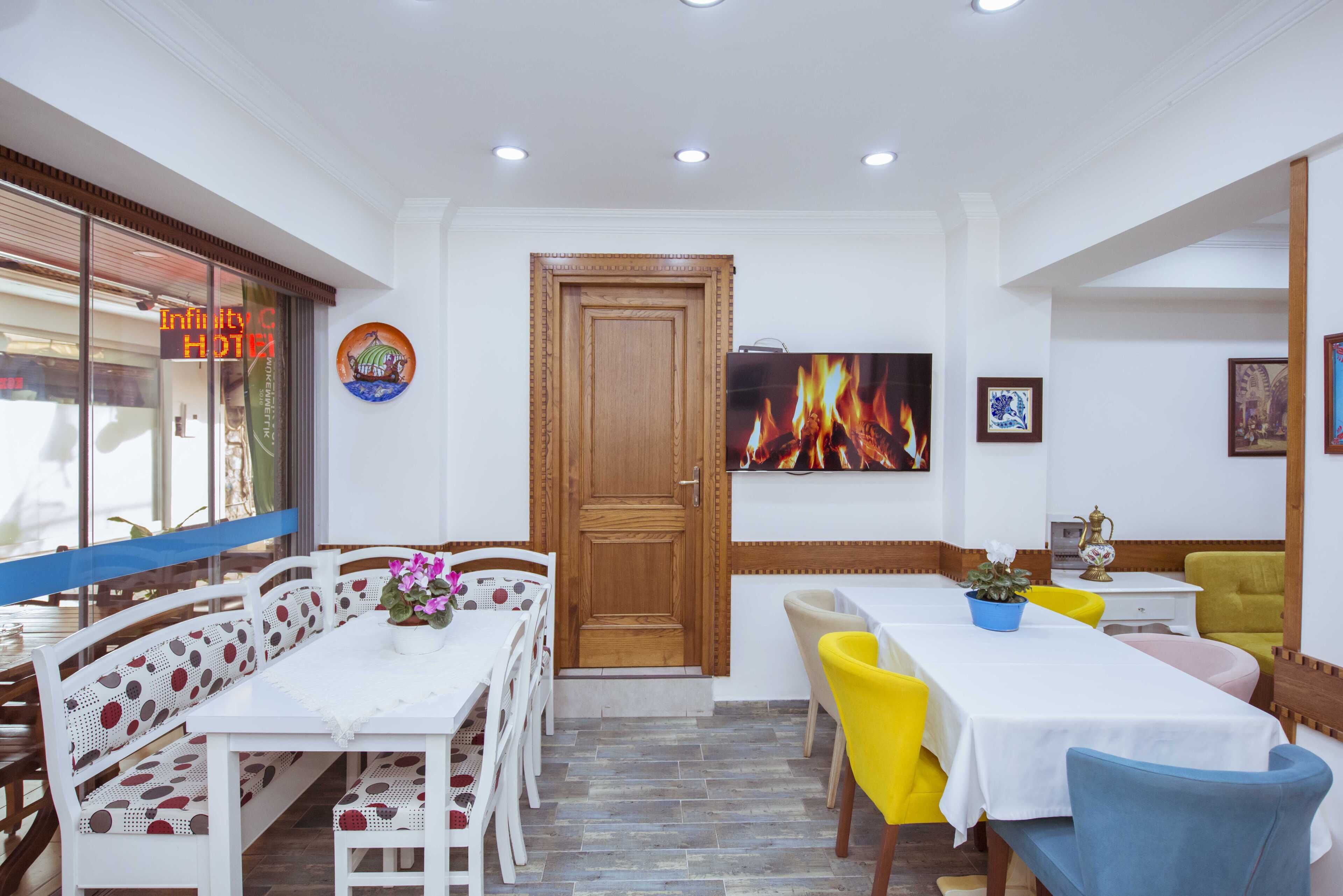 A dining area with a white table, chairs, and a wooden door.