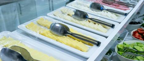 A buffet with various food items and utensils.