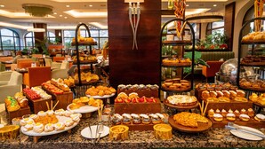A buffet with various pastries and desserts.