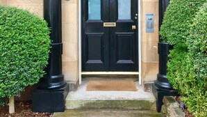 A black double door with a sign above reading "DR BOUTIQUE GUEST HOUSE". - 94DR (Edinburgh)