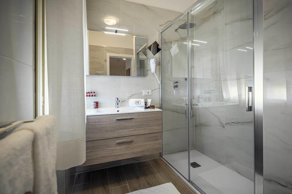 classic quadruple room, multiple beds | bathroom | shower, free toiletries, hair dryer, slippers