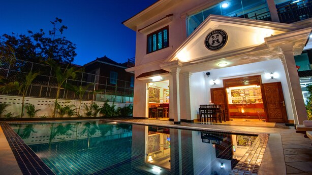 Un hôtel à deux étages doté d’une piscine, d’un bar et d’un restaurant.