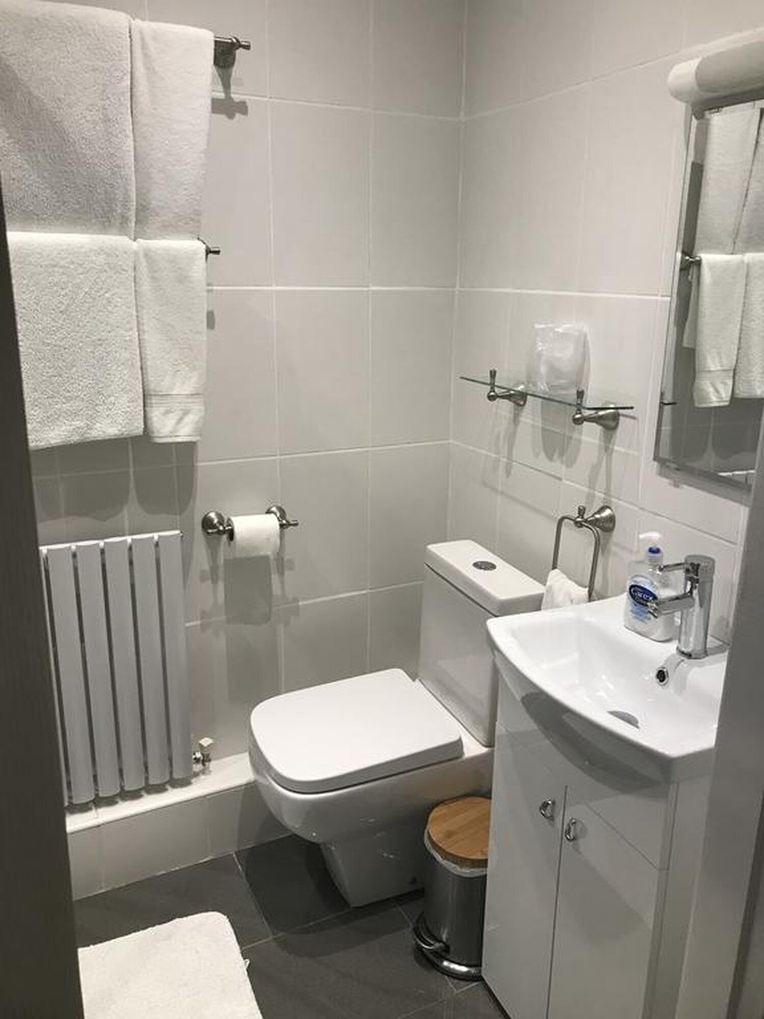 A modern bathroom with a toilet, sink, and shower.