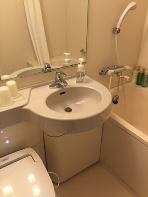 A bathroom with a white sink, a mirror, a handheld showerhead, and a toilet. - Hotel Hokke Club Shonan - Fujisawa (Fujisawa)