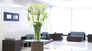 A modern lobby with seating areas and a central vase of flowers. - Hotel Hokke Club Shonan - Fujisawa (Fujisawa)