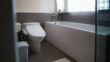 Un baño moderno con inodoro, bidé y bañera.