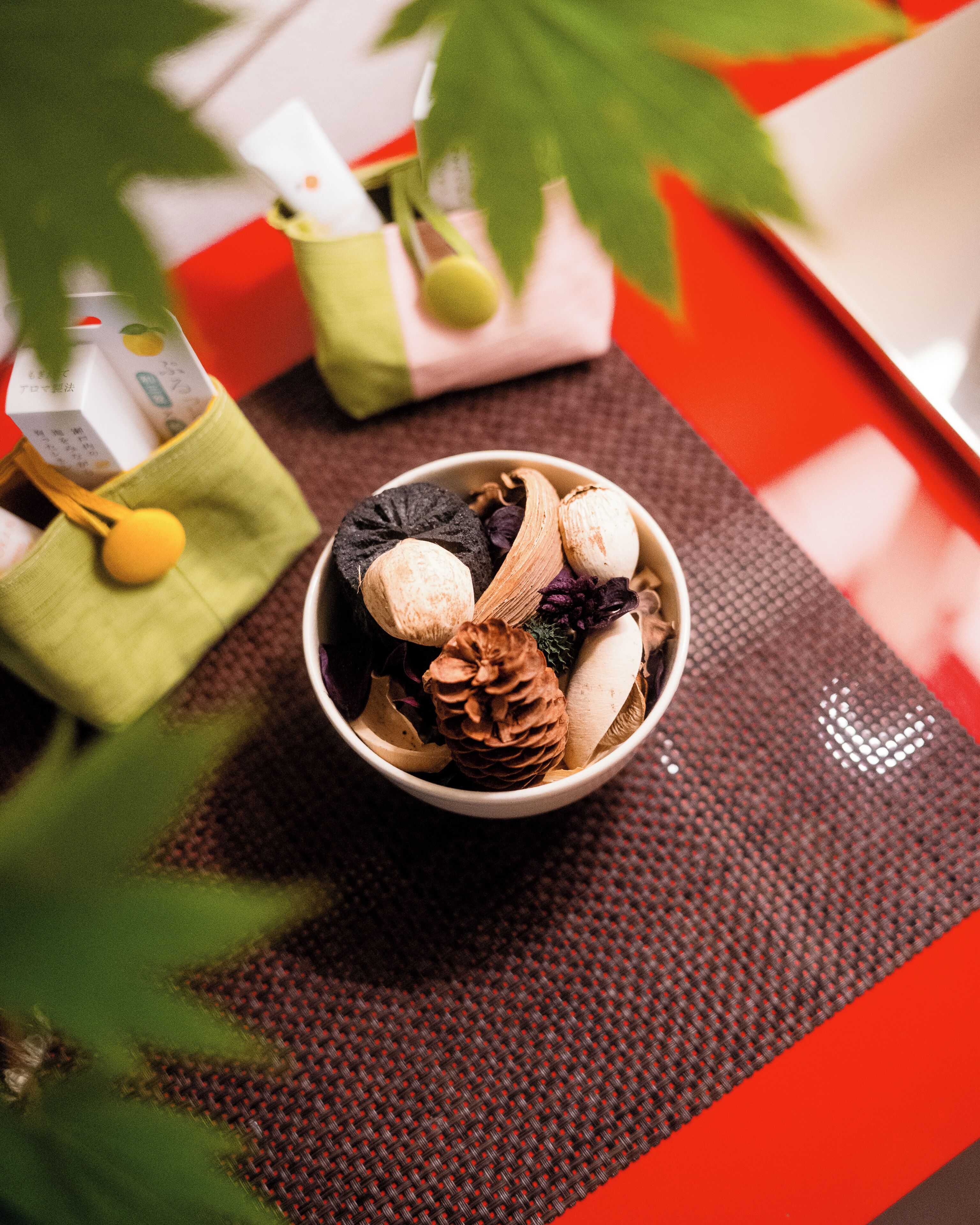 A bowl of assorted nuts and dried fruits on a woven placemat.