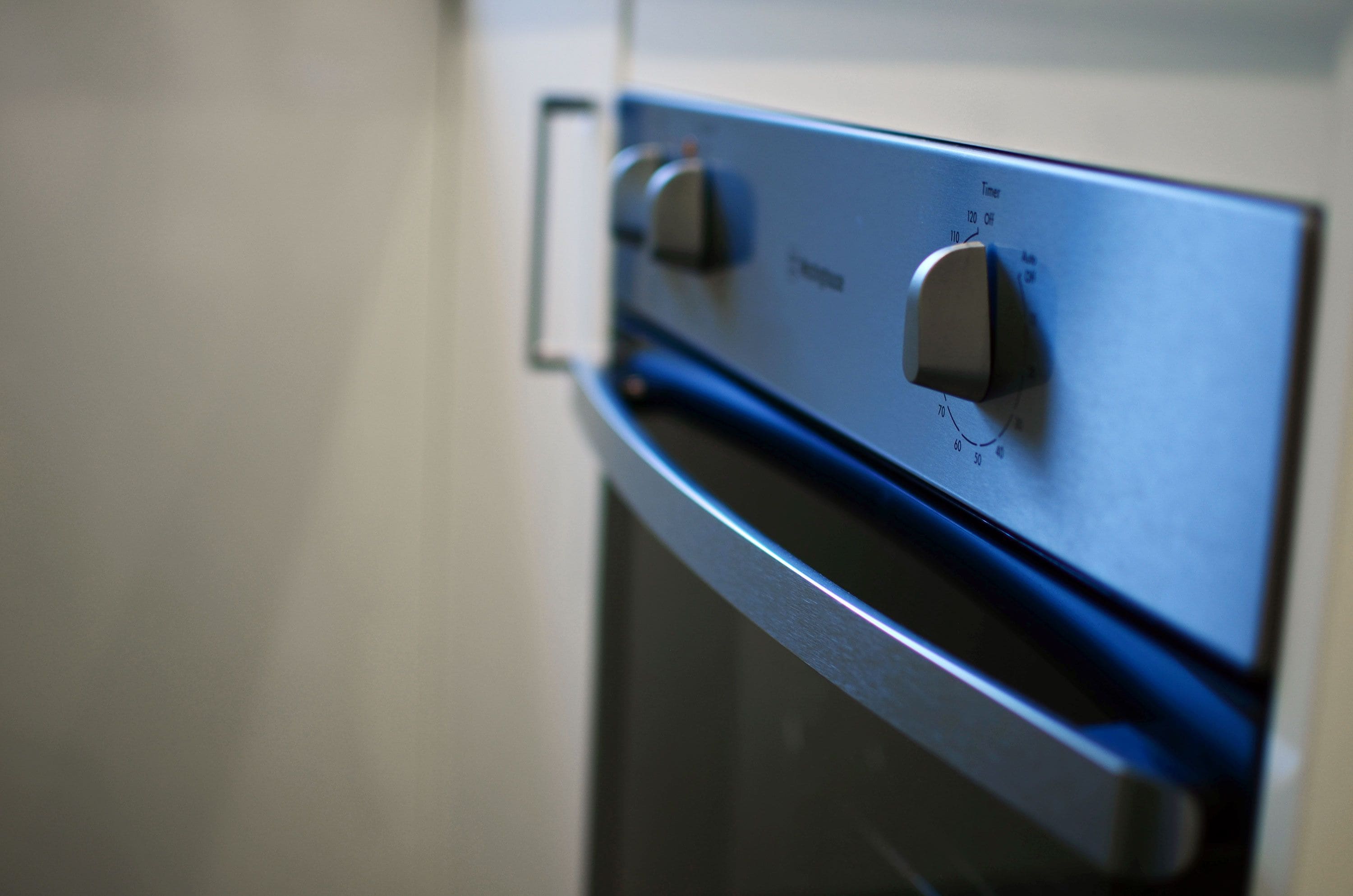 A close-up of an oven control panel with a timer and temperature settings.