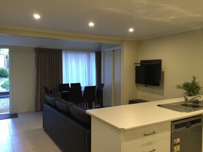 Three Bedroom Apartment | Living area | 42-inch flat-screen TV with satellite channels, TV - Park Squire Motor Inn and Serviced Apartments (Parkville)