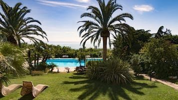 Outdoor pool, a rooftop pool, pool umbrellas, sun loungers