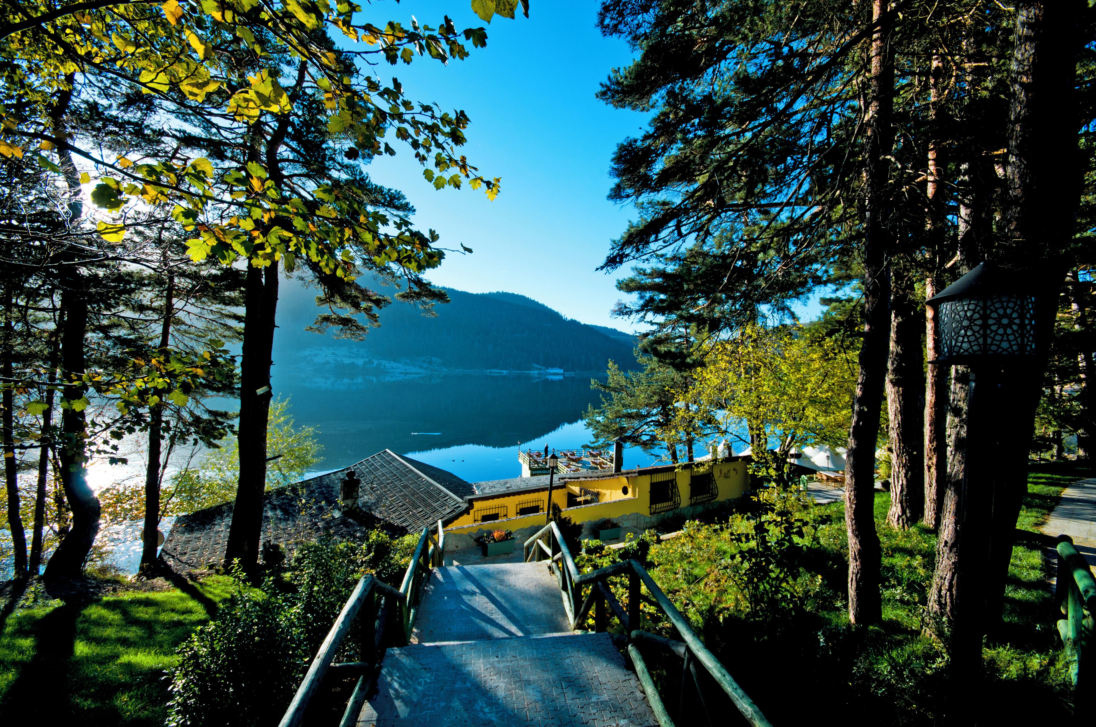 A staircase leading to a building with a view of a lake and mountains.