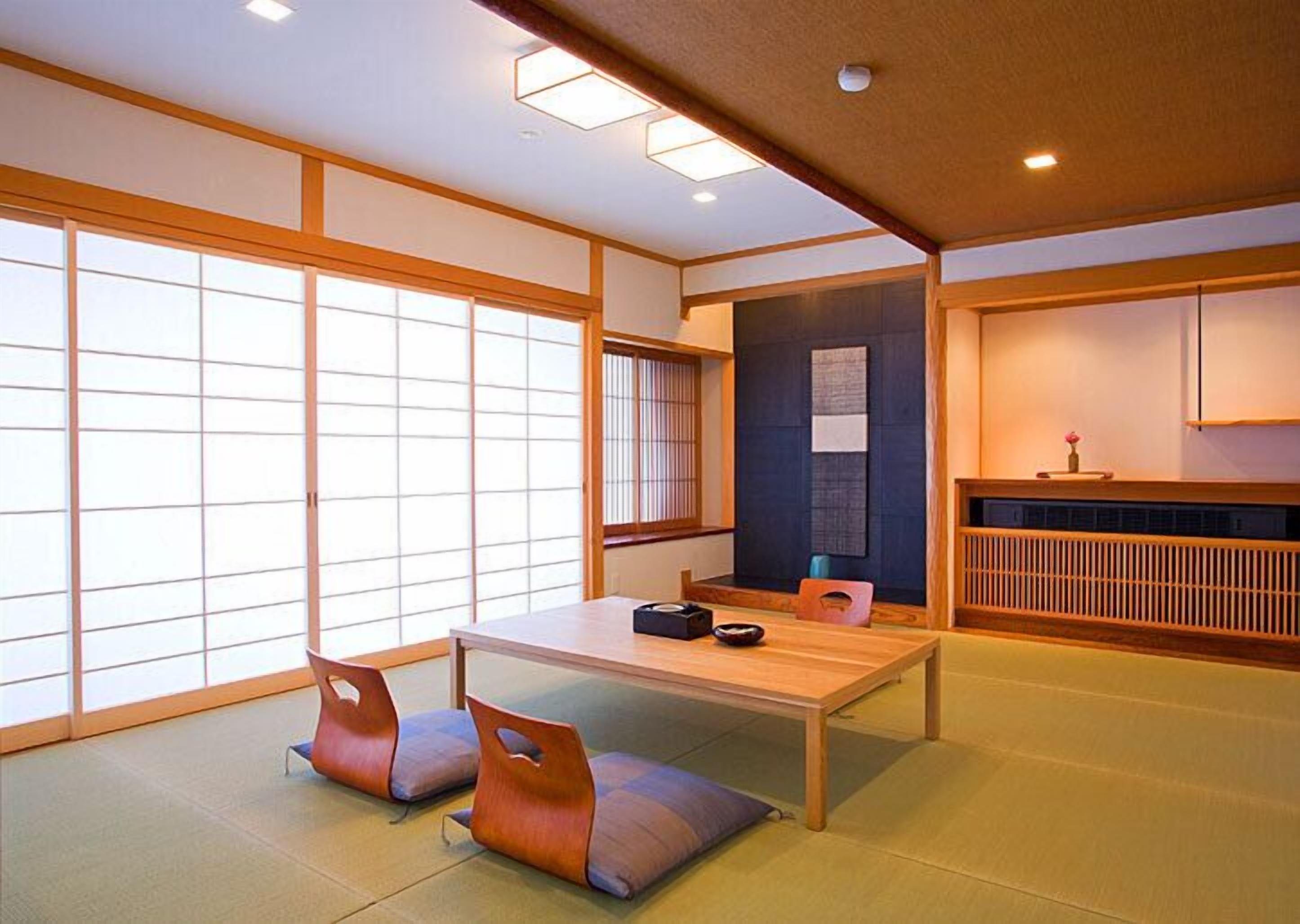 A traditional Japanese room with tatami flooring, a low table, and shoji screens.