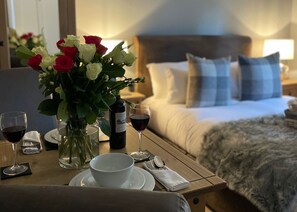 Enjoy a romantic dinner for two in this inviting room, complete with a plush bed and elegant dining area.