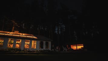 A house with a porch and a covered area with chairs.