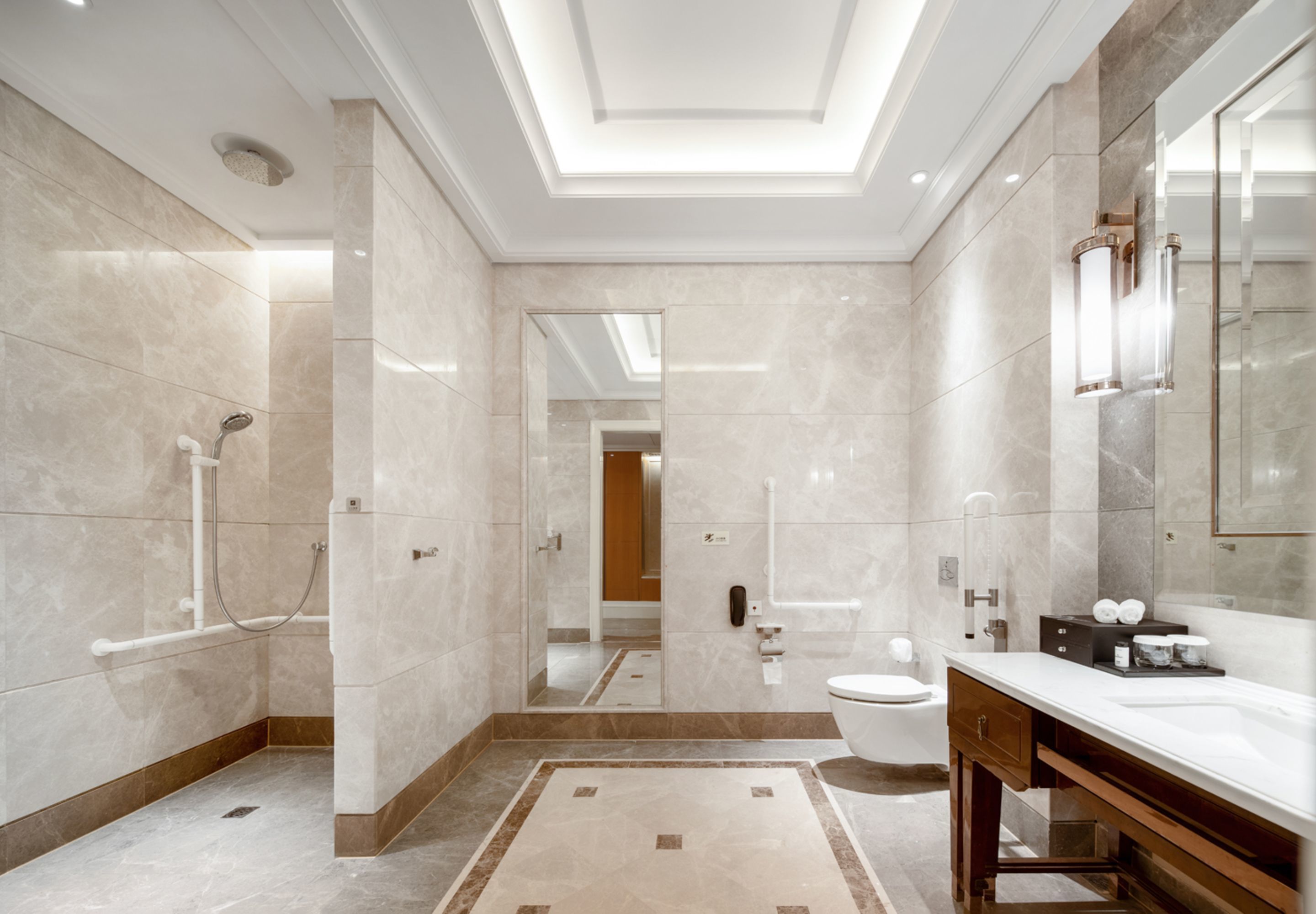 A modern bathroom with a shower, toilet, and vanity.
