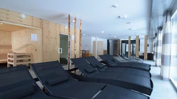 Relax in a serene space with lounge chairs, a sauna, and a reception area.