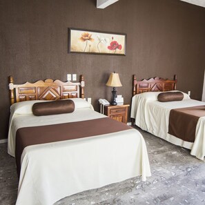 A hotel room with two beds, a nightstand, a lamp, and a painting on the wall. - Hotel San Jorge (Tepic)