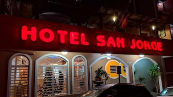 A hotel sign reading "HOTEL SAN JORGE" with arched windows and a plant in the center.