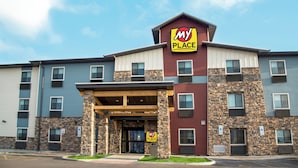 A multi-story hotel with a prominent 'My Place Hotels' sign, a covered entrance, and a stone facade. - My Place Hotel - Sioux Falls, SD (Sioux Falls)