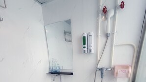 A modern bathroom with a white sink, toilet, and shower. - Tempo Inn West Kowloon HSR Station (Kowloon)